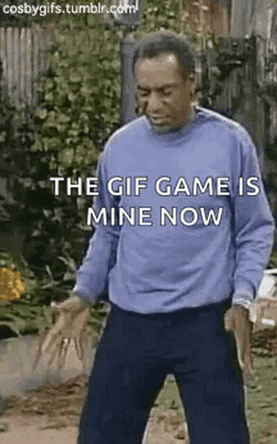 A Man In A Blue Sweater Is Standing On A Sidewalk With His Hands Outstretched And A Gif Game Is Mine Now . GIF