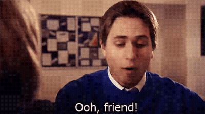 A Man In A Blue Sweater Is Talking To A Woman And Says Ooh Friend GIF
