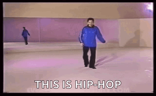 A Man In A Blue Sweater Is Walking On A Purple Ice Rink . GIF