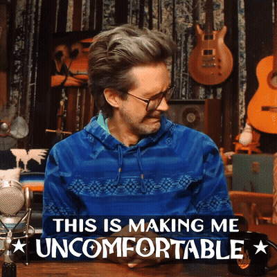 A Man In A Blue Sweater With The Words This Is Making Me Uncomfortable Below Him GIF