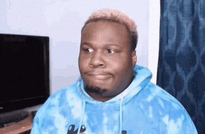 A Man In A Blue Tie Dye Hoodie Is Making A Funny Face GIF