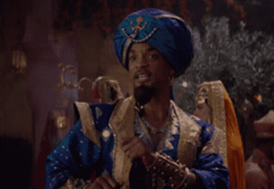 A Man In A Blue Turban Is Talking On A Cell Phone GIF