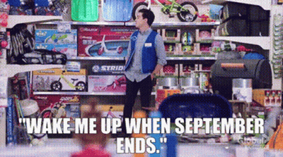 A Man In A Blue Vest Is Standing In Front Of A Shelf Of Toys . GIF