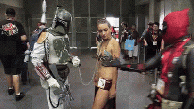 A Man In A Boba Fett Costume Is Holding A Woman In A Leia Costume GIF