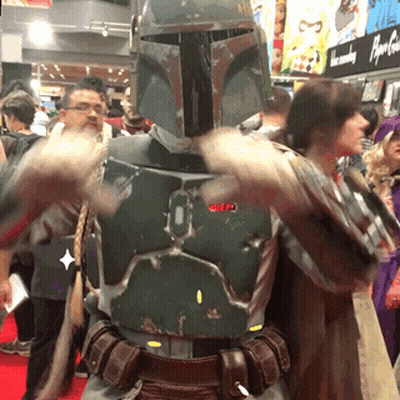 A Man In A Boba Fett Costume Stands In Front Of A Crowd GIF
