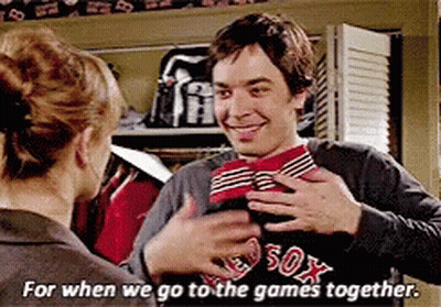 A Man In A Boston Red Sox Shirt Is Hugging A Woman GIF
