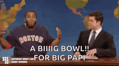 A Man In A Boston Red Sox Shirt Is Sitting Next To A Man In A Suit On A Saturday Night Live Show . GIF