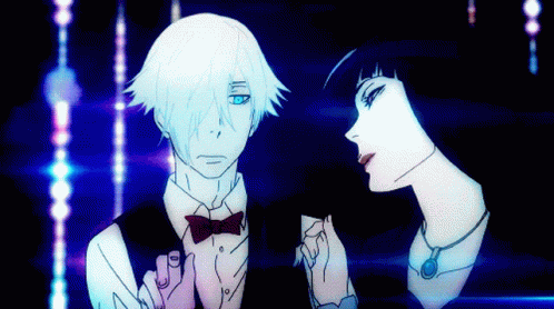 A Man In A Bow Tie Is Standing Next To A Woman GIF
