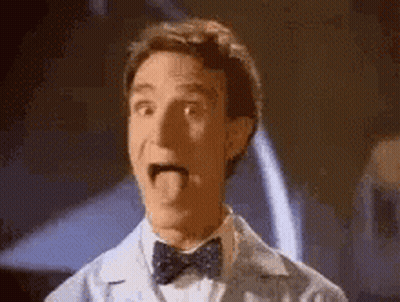 A Man In A Bow Tie Is Sticking His Tongue Out And Making A Funny Face . GIF