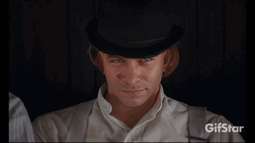 A Man In A Bowler Hat Is Drinking Milk From A Carton GIF