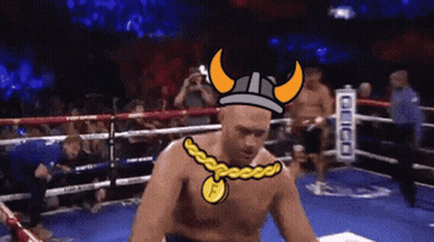 A Man In A Boxing Ring Wearing A Viking Helmet And A Necklace With The Letter F On It GIF