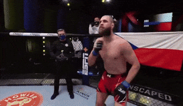 A Man In A Boxing Ring With A Banner That Says Scaped On It GIF