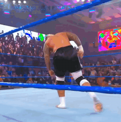 A Man In A Boxing Ring With A Crowd Behind Him GIF