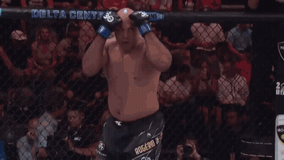 A Man In A Boxing Ring With A Delta Center Banner In The Background GIF