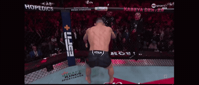 A Man In A Boxing Ring With A Espn Banner Behind Him GIF