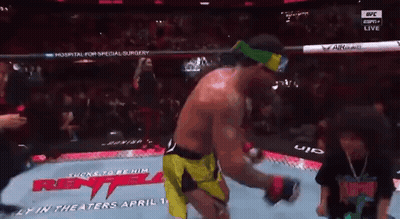 A Man In A Boxing Ring With A Sign That Says ' Rent ' On It GIF