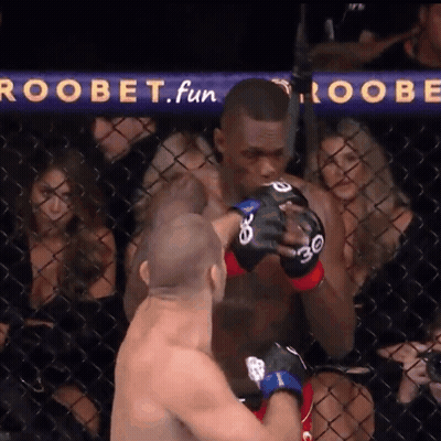 A Man In A Boxing Ring With A Sign That Says Roobet Fun GIF