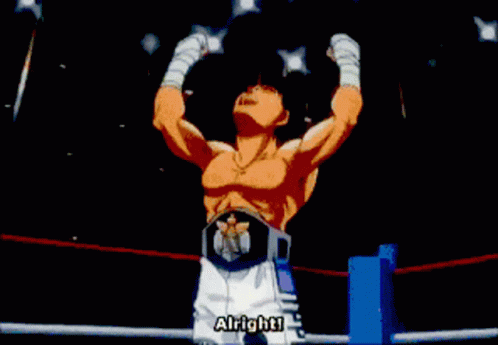 A Man In A Boxing Ring With His Arms Up GIF