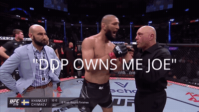 A Man In A Boxing Ring With The Words " Ddp Owns Me Joe " At The Top GIF