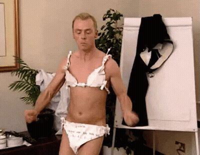 A Man In A Bra And Panties Is Standing In Front Of A White Board . GIF