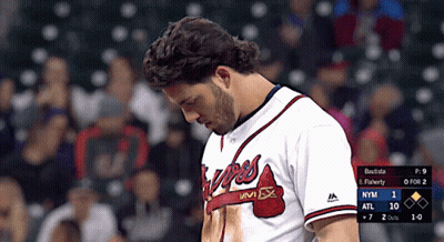 A Man In A Braves Jersey Looks Down At The Scoreboard GIF