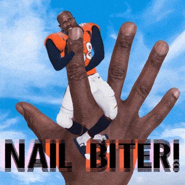 A Man In A Broncos Jersey Is Being Held Up By A Large Hand That Says Nail Biter GIF