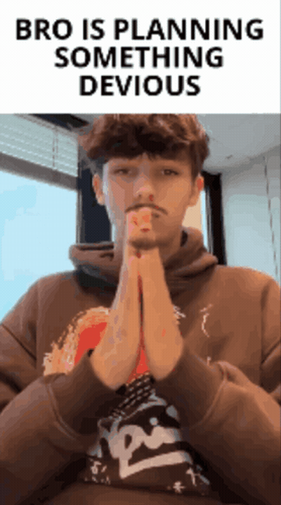 A Man In A Brown Hoodie Is Praying With The Words Bro Is Planning Something Devious Behind Him GIF