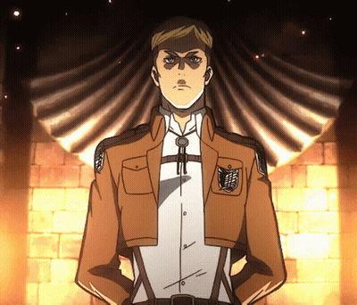 A Man In A Brown Jacket And White Shirt Stands With His Hands On His Hips In Front Of A Brick Wall GIF