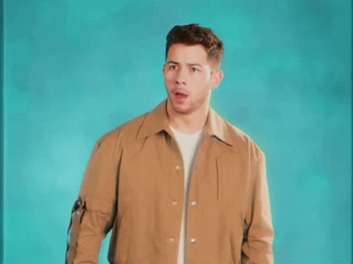 A Man In A Brown Jacket Is Making A Surprised Face . GIF