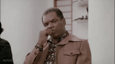 A Man In A Brown Jacket Is Smoking A Cigarette In A Movie Clip GIF