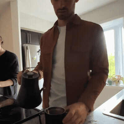 A Man In A Brown Jacket Pouring A Cup Of Coffee GIF