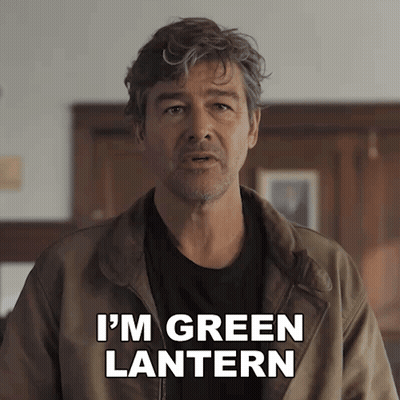 A Man In A Brown Jacket Says " I 'M Green Lantern " To The Camera GIF