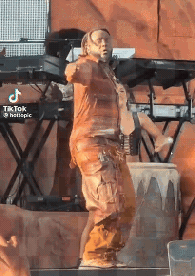 A Man In A Brown Outfit Is Dancing On A Stage With A Tiktok Watermark GIF