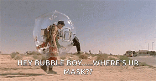 A Man In A Bubble Suit Is Walking Down A Road And Talking To Another Man In A Bubble Suit . GIF