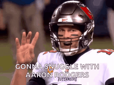A Man In A Buccaneers Jersey Is Waving His Hand GIF
