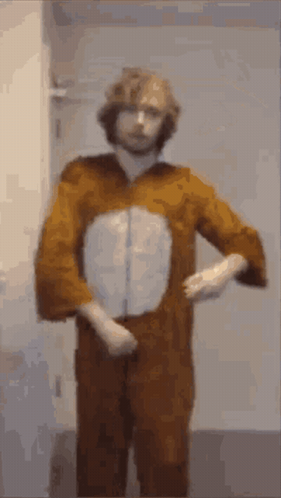A Man In A Bunny Costume Is Standing In Front Of A Door . GIF