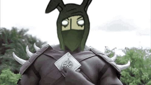A Man In A Bunny Mask Is Holding A Card GIF