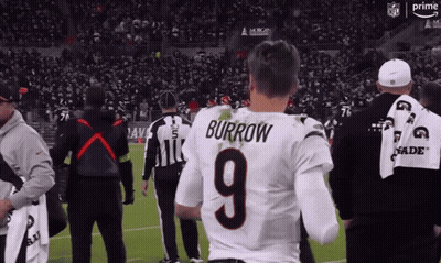 A Man In A Burrow 9 Jersey Stands On A Football Field GIF