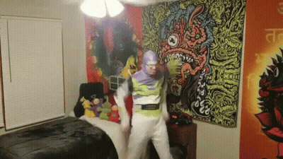 A Man In A Buzz Lightyear Costume Is Dancing In A Room GIF