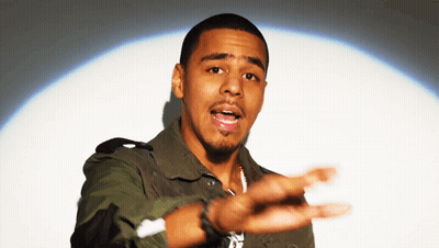 A Man In A Camouflage Jacket Is Reaching Out His Hand GIF