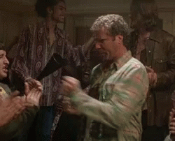A Man In A Camouflage Shirt Is Dancing In A Crowd Of People . GIF
