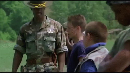 A Man In A Camouflage Uniform Has A Badge On His Chest That Says ' Army ' GIF