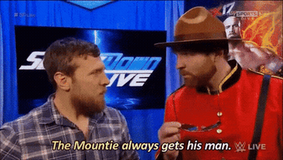 A Man In A Canadian Uniform Is Talking To Another Man In A Plaid Shirt GIF