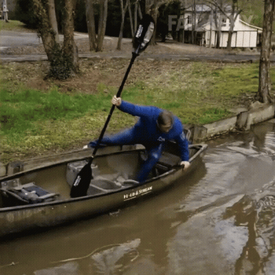 A Man In A Canoe With A Paddle That Says Prada Stream On It GIF
