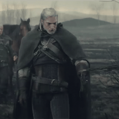 A Man In A Cape Is Standing Next To A Horse GIF