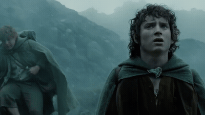 A Man In A Cape Stands In Front Of A Mountain Looking Up GIF