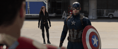 A Man In A Captain America Costume Holds A Shield GIF