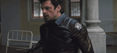 A Man In A Captain America Costume Is Being Held By Another Person GIF