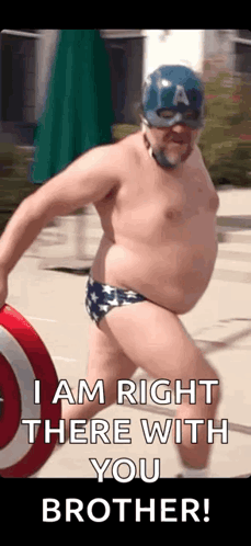 A Man In A Captain America Costume Is Holding A Shield And A Shield . GIF