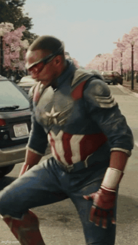 A Man In A Captain America Costume Is Kneeling Down GIF